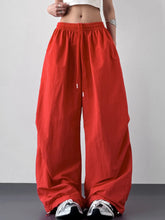 Red wide leg drawstring pants with elastic waistband designed for comfortable everyday wear