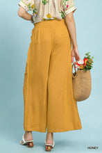 Umgee linen wide leg pants in honey with frayed hem and relaxed flowing silhouette featuring side pockets