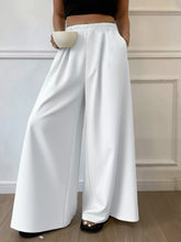 Plus size elastic white wide leg pants with elastic waistband and smooth flowing fabric for comfortable wear