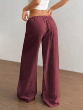 Maroon full size drawstring wide leg pants with pleats and soft flowing fabric featuring an elastic waistband