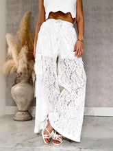 White lace wide-leg pants with a drawstring waist and side pockets offering a stylish lace wide-leg fit