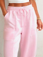 Soft pink casual drawstring sweatpants with high waist, elastic waistband, side pockets, and machine wash care instructions
