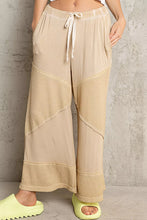 Beige pol elastic waistband wide leg pants with drawstring and textured fabric panels for comfortable wear