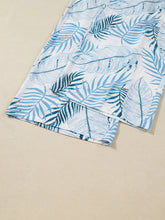 White shorts with vibrant blue tropical print and shirred waistband perfect for stylish summer wear