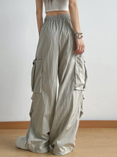 Light gray drawstring wide leg cargo pants with multiple pockets and elastic waistband for comfortable wear