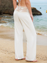 White wide leg pants with crochet waist wide waistband and shell embellishments for a stylish summer look