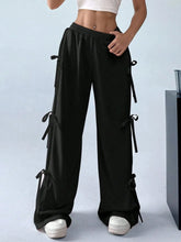 Black cargo wide leg pants featuring side tie details for a stylish and comfortable wide leg pants look