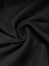 Black textured fabric with subtle ribbed weave for high-waisted wide-leg pants showcasing wide leg design