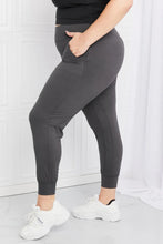 Dark gray pocketed high-waist pants leggings depot full size with side pockets and snug fit paired with ankle boots