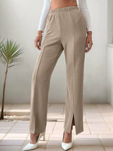 Beige ribbed wide-leg high-waisted slit pants with an elastic waist and side slit for stylish comfort