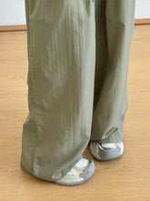 Olive green wide leg drawstring casual pants with relaxed fit and slightly wrinkled fabric texture