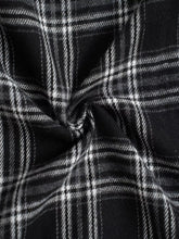 Black and white plaid relaxed fit pants featuring a textured woven fabric for comfortable everyday wear