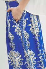 Vibrant royal blue umgee border print wide leg pants with cream embroidered floral and vine patterns and subtle mesh texture