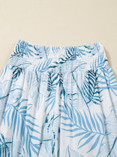 White tropical print shirred waistband wide leg pants with blue leaf pattern and elastic waistband detail