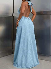 A flowing light blue denim maxi dress with a halter neckline and tied-back straps backless denim maxi dress
