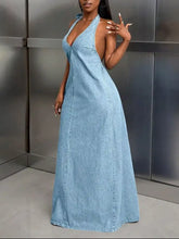 Back view of a light blue denim maxi dress with a backless halter neck and subtle stitching details