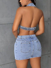 Light-wash denim mini dress with backless sleeveless design and button front detailing for stylish wear