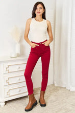 Basic bae full size round neck tank paired with high-waisted red skinny jeans size with classic five-pocket design