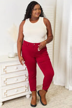 Red high-waisted slim fit jeans in classic denim material paired with basic bae tank featuring a full size round neckline