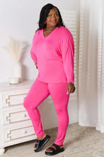 A vibrant pink basic bae full size v-neck soft rayon long sleeve top and pants lounge set in stretchy fabric