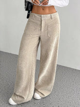 Beige corduroy wide-leg pants with button closure and front pockets featuring corduroy texture for ankle boots styling