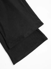 Black relaxed fit drawstring pants with smooth matte fabric and clean stitching along the hem