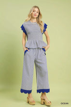 Blue and white striped peplum top with ruffled sleeves paired with umgee stripe scallop hem wide leg pants
