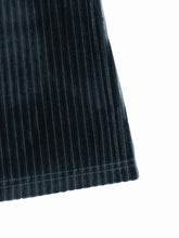 A dark navy blue high-waisted ribbed velvet flare pants with pleated soft textured luxurious velvet fabric