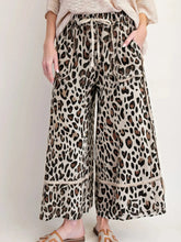 Beige leopard print wide leg drawstring pants featuring a ruffled hem for stylish casual wear