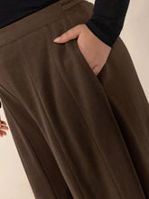 Plus size wide leg brown pleated trousers with soft flowing fabric and elastic waistband featuring pockets