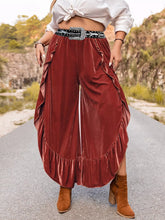 Plus size velvet ruffle hem wide leg pants in burgundy velvet with high waist and side slit design