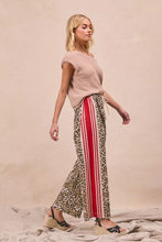 BiBi leopard print pants featuring wide-leg trousers with bold red and white vertical side stripes and welt pockets