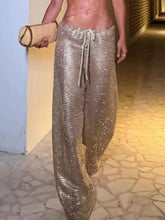 Shiny gold mesh drawstring wide leg pants with a comfortable drawstring waistband and wide leg silhouette