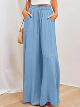 Light blue wide leg pants with elastic waistband drawstring and pockets for comfortable casual wear