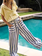 Striped wide-leg drawstring pants in bold navy and cream vertical stripes with a relaxed fit and drawstring waist