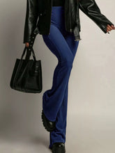 A pair of royal blue high-waisted flared pants with a smooth glossy finish for a perfect fit