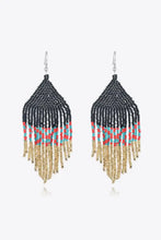 Beaded dangle earrings with black, red, turquoise, and gold fringe