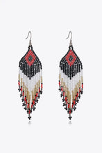 Pair of colorful beaded dangle earrings in red, black, white, and gold