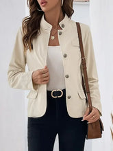 Beige button-up blazer with black pants and white top set