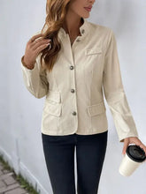 Beige leather jacket in blazer set with cream accents, button closure, and pockets