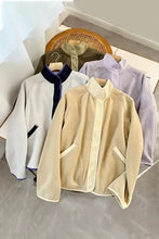 Cream-colored quilted fleece jacket with stand-up collar, patch pockets in every size