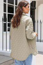 Beige quilted jacket with high collar, long sleeves and pockets