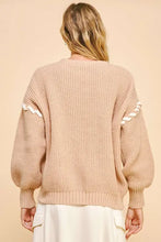 Beige chunky knit cardigan with lace-up ribbon bow and bishop sleeves