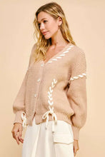Beige chunky knit cardigan with lace-up ribbon bow and bishop sleeves