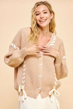 Beige chunky knit cardigan with lace-up ribbon bow accents