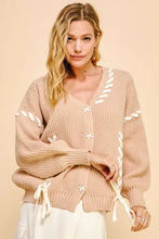 Beige chunky knit cardigan with lace-up ribbon bow and bishop sleeves