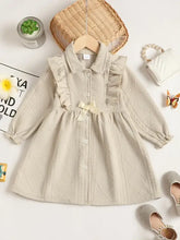 Beige collared neck dress with ruffled bow and pearl embellishments
