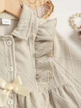 Beige collared neck dress with ruffled bow and cable knit texture