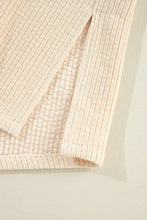 Cream-colored textured sweater with ribbed detailing in beige corduroy jacket