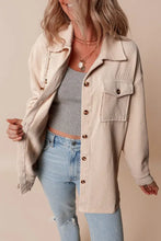 Beige corduroy button-down utility jacket with pockets and relaxed fit